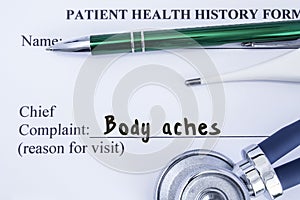 Complaint of Body Ache. Paper health history form, which is written on the patients chief complaint of Body Ache, surrounded by a