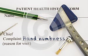 Complaint hand numbness. Patient health history is on table of neurologist, which contains complaint hand numbness surrounded by n photo