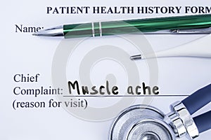 Complaint of muscle ache. Paper health history form, which is written on the patient`s chief complaint of muscle ache, surrounded