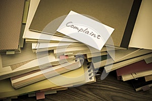 Complaint; The Pile of Business Documents on the Desk