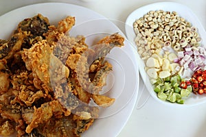 Complementing fish recipe - deep fried fish served with spices, vegetable and special sauce.