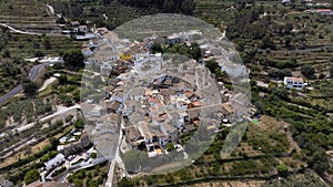 Complete aerial view of the small town of Beniali among fields, located in the Gallinera valley in the north of Alicante, Spain.