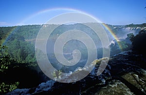 Complete arch rainbow over Iguazu Waterfalls in Parque Nacional Iguazu, border of Brazil and Argentina