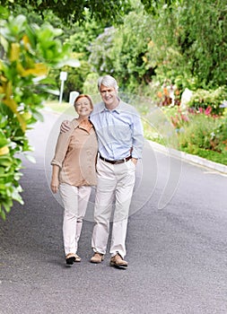 We complete each other. Portrait of a cheerful senior couple taking a stroll.