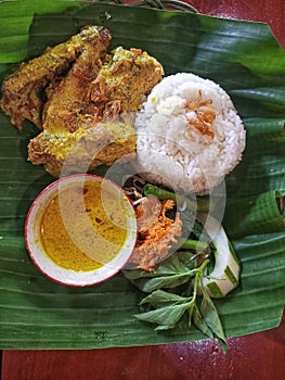 a complete portion of lodho chicken typical of Tulungagung district on a banana leaf basis