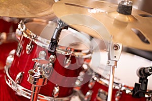 Complete set of cymbal instruments with complete red drums in studio music concept