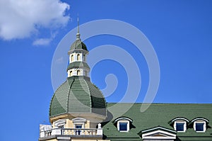 Completed perfect high-quality roofing work from metal roofing. The dome of a polyhedral shape with a spire is covered with green