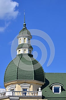 Completed perfect high-quality roofing work from metal roofing. The dome of a polyhedral shape with a spire is covered with green
