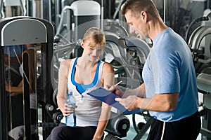 Completing personal fitness plan with trainer