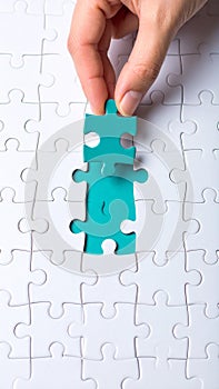 Completing the Puzzle Person hand placing the final piece of jigsaw puzzle on white background solving the problem