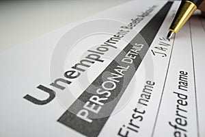 Completing unemployment benefits application form photo