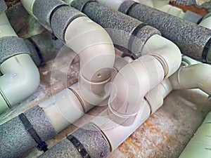 Complex Network of Insulated Pipes in an Industrial Setting. maze of thermally insulated pipes arranged in a complex