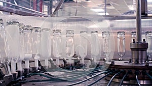 Complex for the production of glass bottles and drinks. Clip. Mechanical machine in a factory with the manufacture of