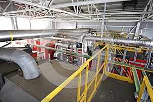 Complex system of steam generation vessels, pipelines pumps valves working in the production hall of the biggest in photo