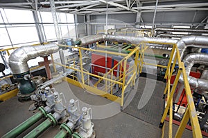 Complex system of steam generation vessels, pipelines pumps valves working in the production hall of the biggest in photo