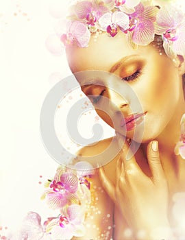 Complexion. Gorgeous Woman with Perfect Bronzed Skin and Orchid Flowers. Fragrance