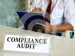 Compliance audit concept. Auditor checks the papers.