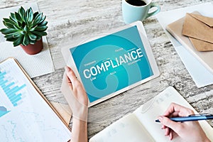 Compliance concept with icons and diagrams. Regulations, law, standards, requirements, audit. Concept on device screen photo