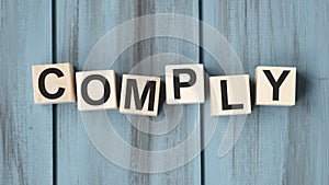COMPLY word written on building blocks