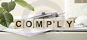 COMPLY word written on building blocks concept photo