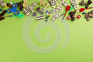 Components of board games on green background, flat lay. Space for text