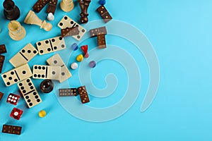 Components of board games on light blue background, flat lay. Space for text