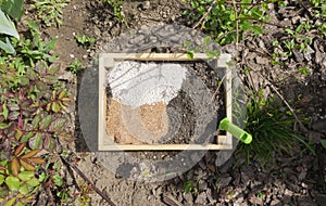 The components of the soil mixture: vermiculite, compost, vermicompost, biohumus, agroperlite and vermiculite in a wooden box for