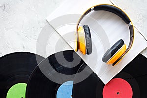 Compose music. Vinyl records, headphones, music notes on grey background top view copyspace