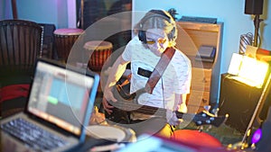 Composer guitarist playing the guitar while recording a new album, jam session