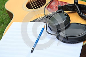 Composer write note of song and use acoustic guitar