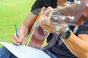 Composer write note of song and use acoustic guitar