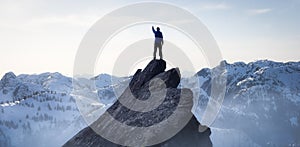 Composite. Adventurous Man Hiker on top of a Steep Rocky Cliff.