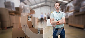 Composite 3d image of serious warehouse manager standing with arms crossed