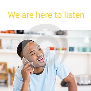 Composite of we are here to listen text and happy african american young man talking on smartphone