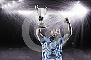 Composite image 3D of happy sportsman looking up and cheering while holding trophy