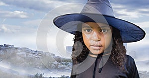 Composite image of african american girl in a witch against winter landscape