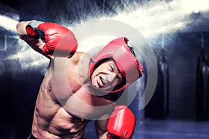 Composite image of aggressive boxer against black background