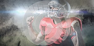 Composite image of american football player cheering with clenched fist