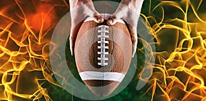 Composite image of american football player holding up football