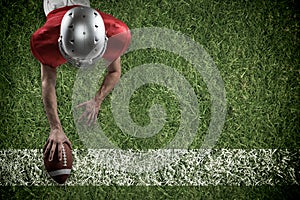 Composite image of american football player lying in front with ball