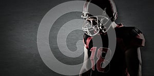 Composite image of american football player standing in rugby helmet