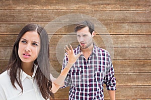 Composite image of angry brunette not listening to her boyfriend