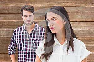 Composite image of angry brunette not listening to her boyfriend