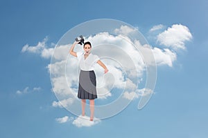 Composite image of angry businesswoman throwing binoculars away