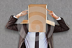 Composite image of anonymous businessman pointing to box