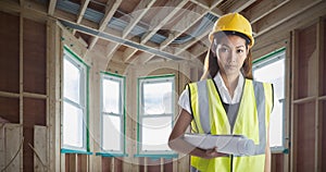 Composite image of architect woman with yellow helmet and plans