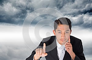 Composite image of asian businessman pointing