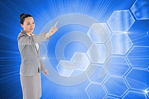 Composite image of asian businesswoman pointing