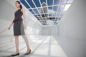 Composite image of asian businesswoman walking