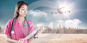 Composite image of asian nurse with stethoscope looking at the camera